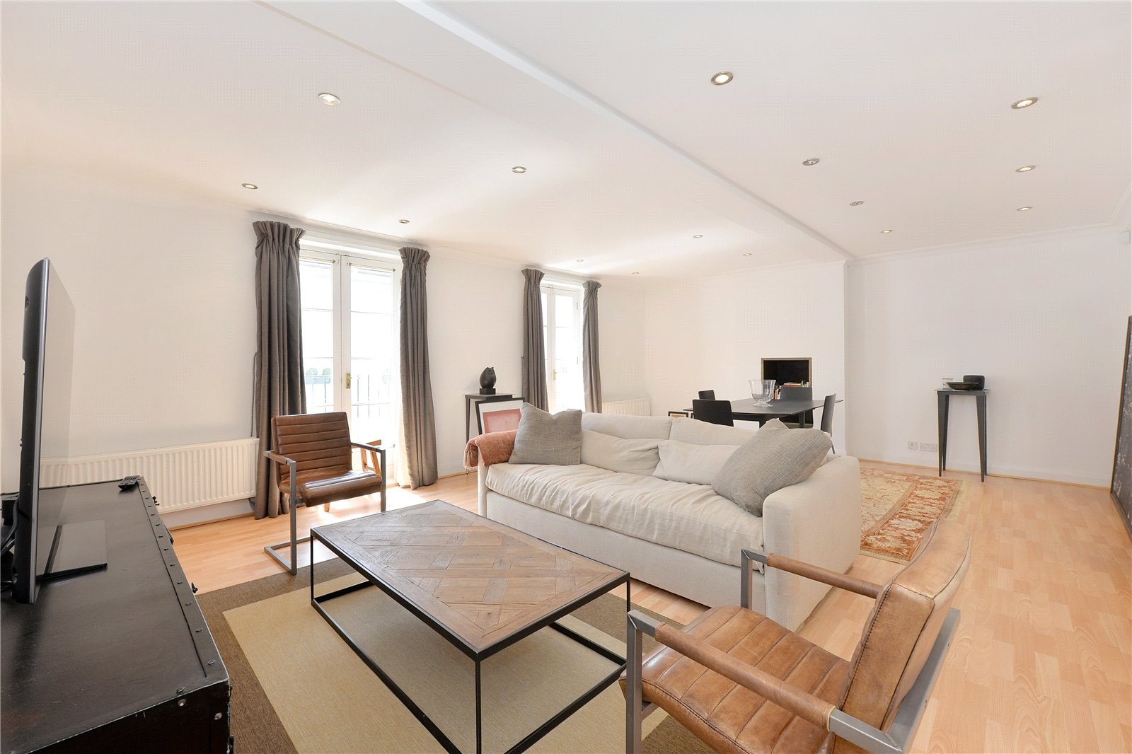 Modern interior living room with natural light, neutral colour palette, and contemporary furniture.