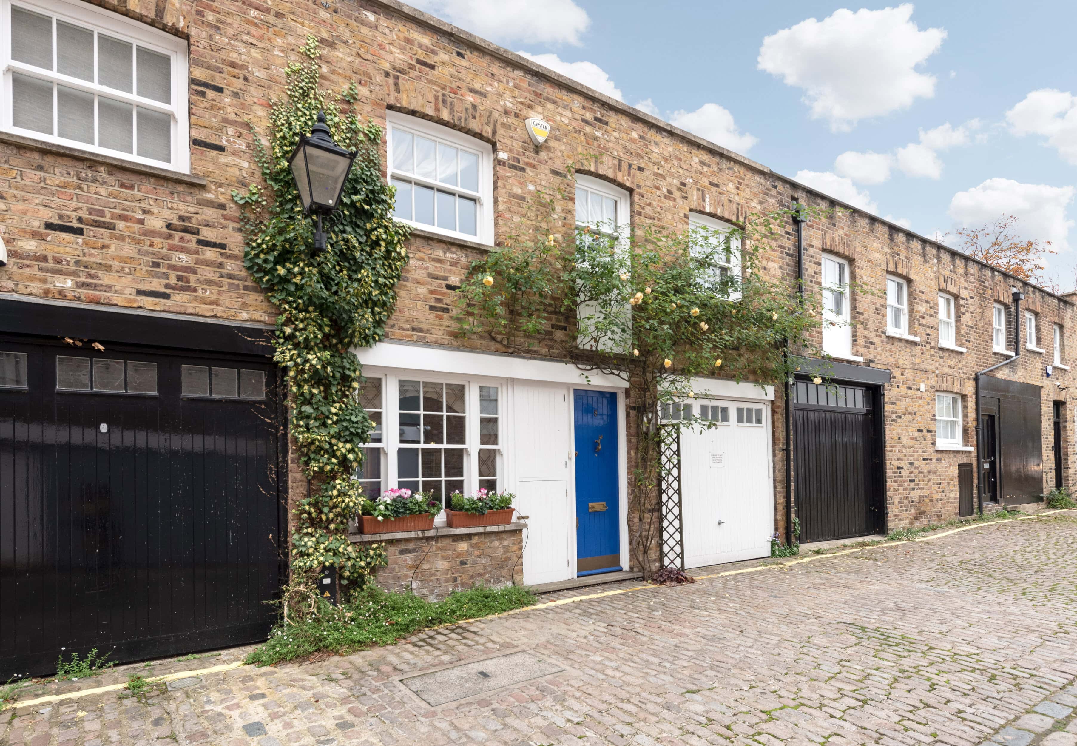 Traditional London townhouse with brick facade and greenery.