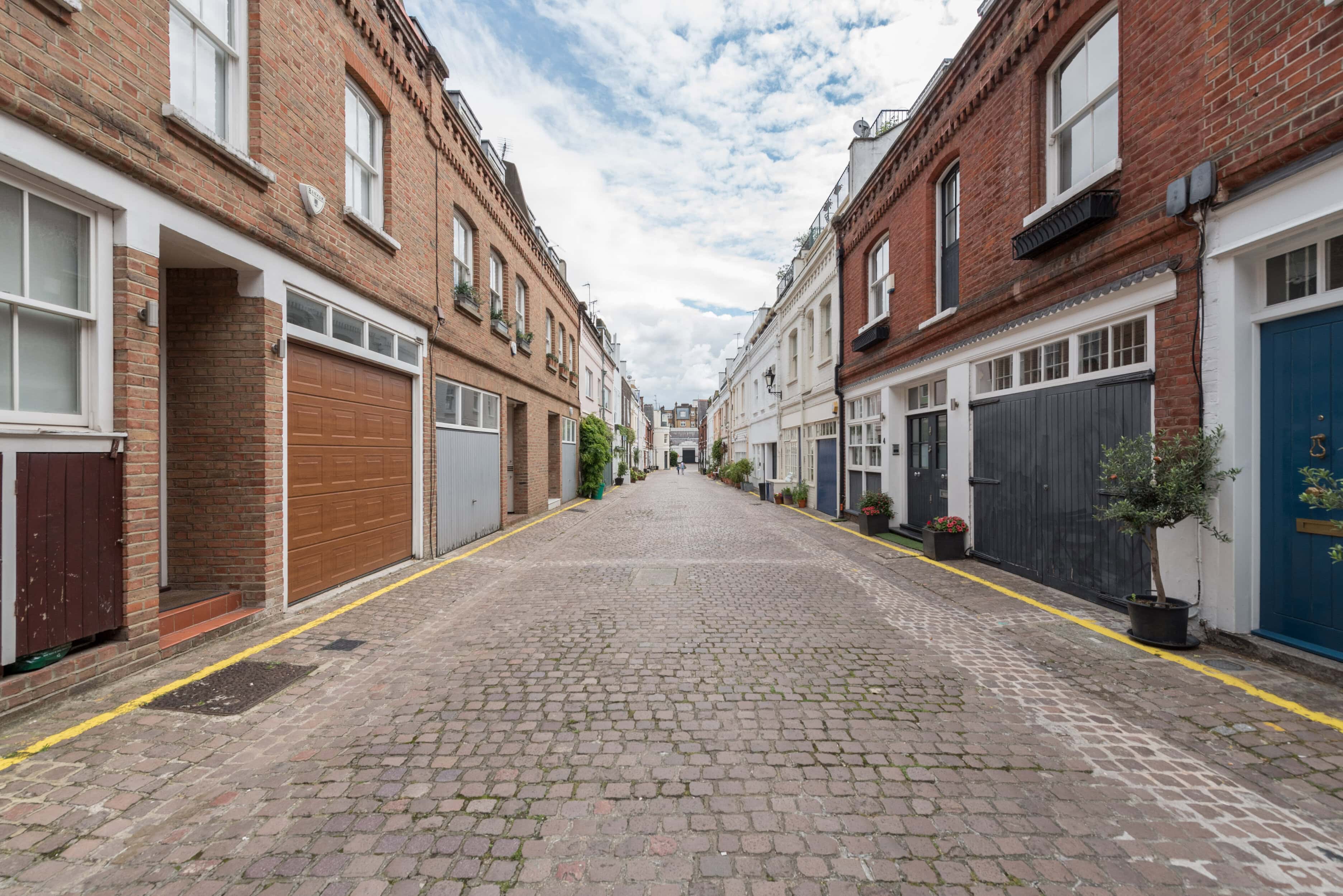 Adam and Eve Mews, a quiet cobbled street Kensington with historic brick houses.
