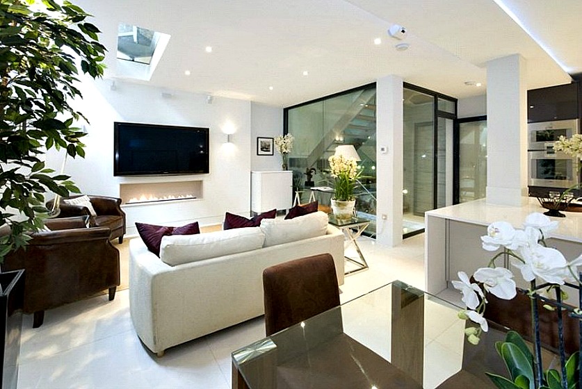 A tasteful modern conversion of the below stairs open-plan reception of this Kensington Mews provides a stunning light-filled space for relaxing and dining.