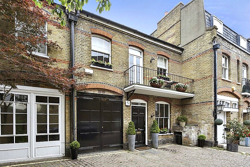Stripped brick walls, carriage house doors, cobbles, narrow doorways and potted greenery are characteristic features of authentic mews houses, built in Central London as working, functional units.