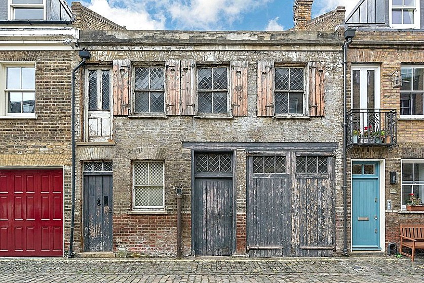 Freehold one-bedroom Pindock mews house with lead-light windows, exposed brick exterior and narrow wooden doors is a bargain if you’re looking for an authentic period Central London mews to refurbish to your own specification.