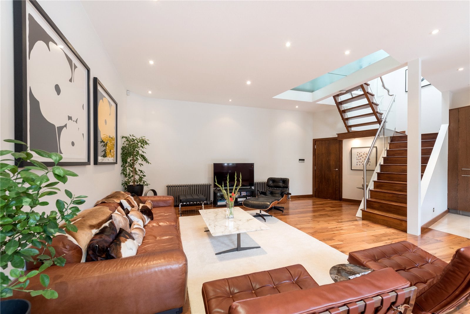 Stylish contemporary living room with wooden flooring and modern furnishings, showcasing London property interior.