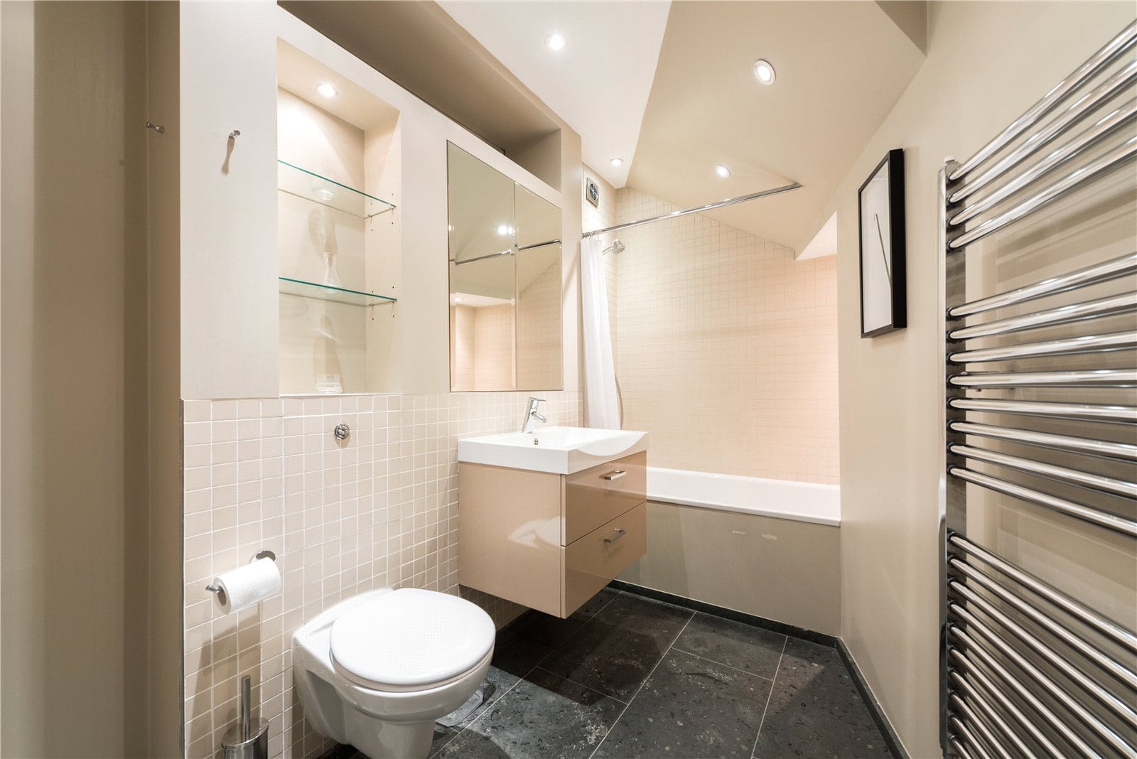Modern bathroom with neutral tones, sleek fixtures, and a walk-in shower. Ideal for luxury property listings.