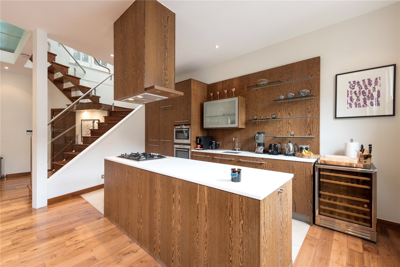 Modern wooden kitchen with island and open shelving, stylish interior design.