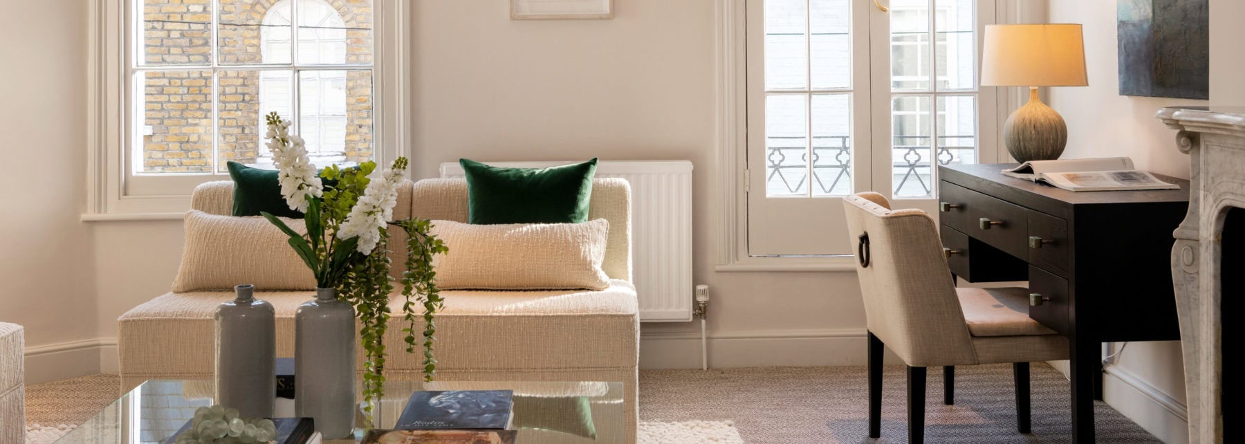 Elegant London apartment living room with contemporary decor and natural light from large windows.