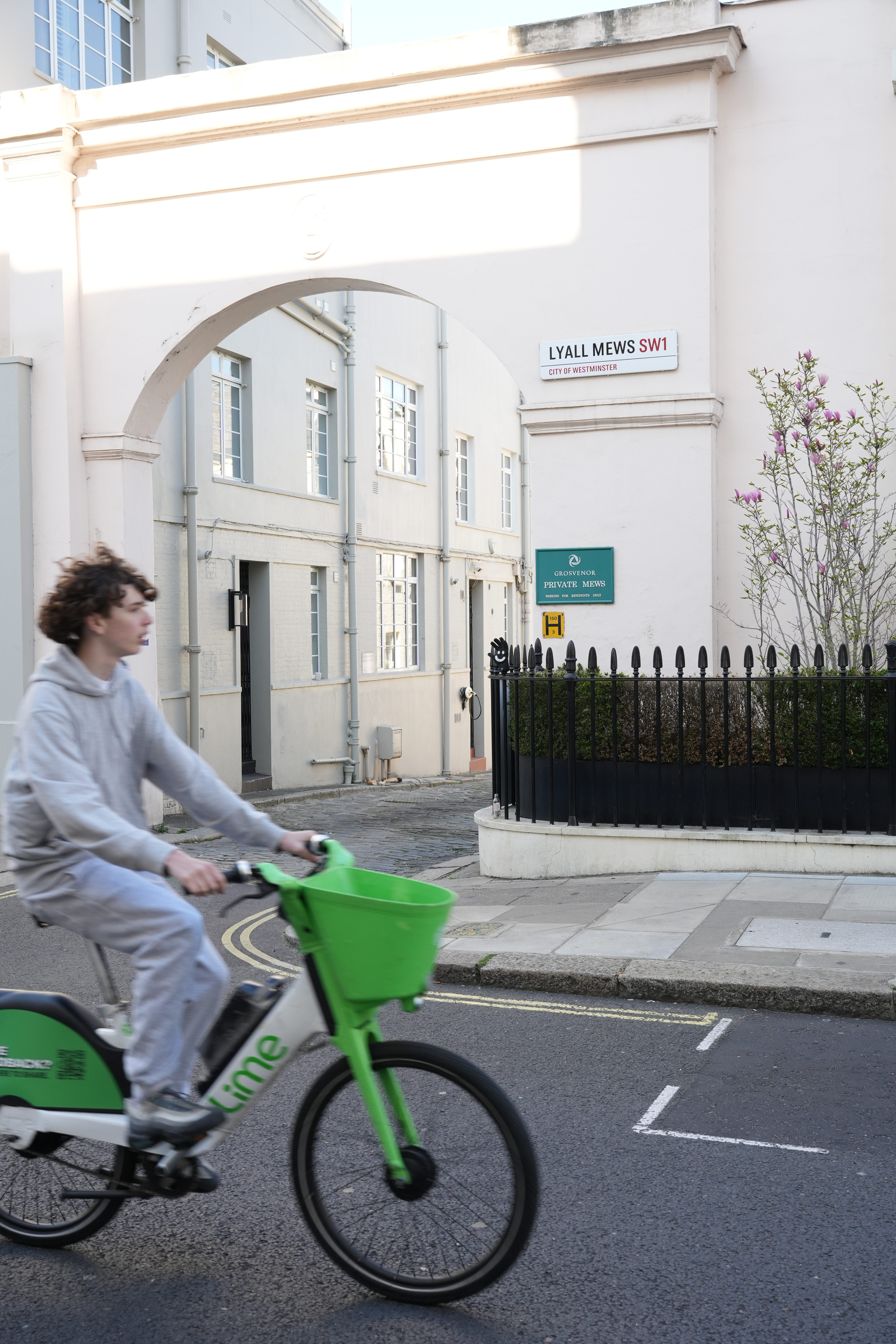 An Arch In Belgravia With A Cyclist Cycling Past