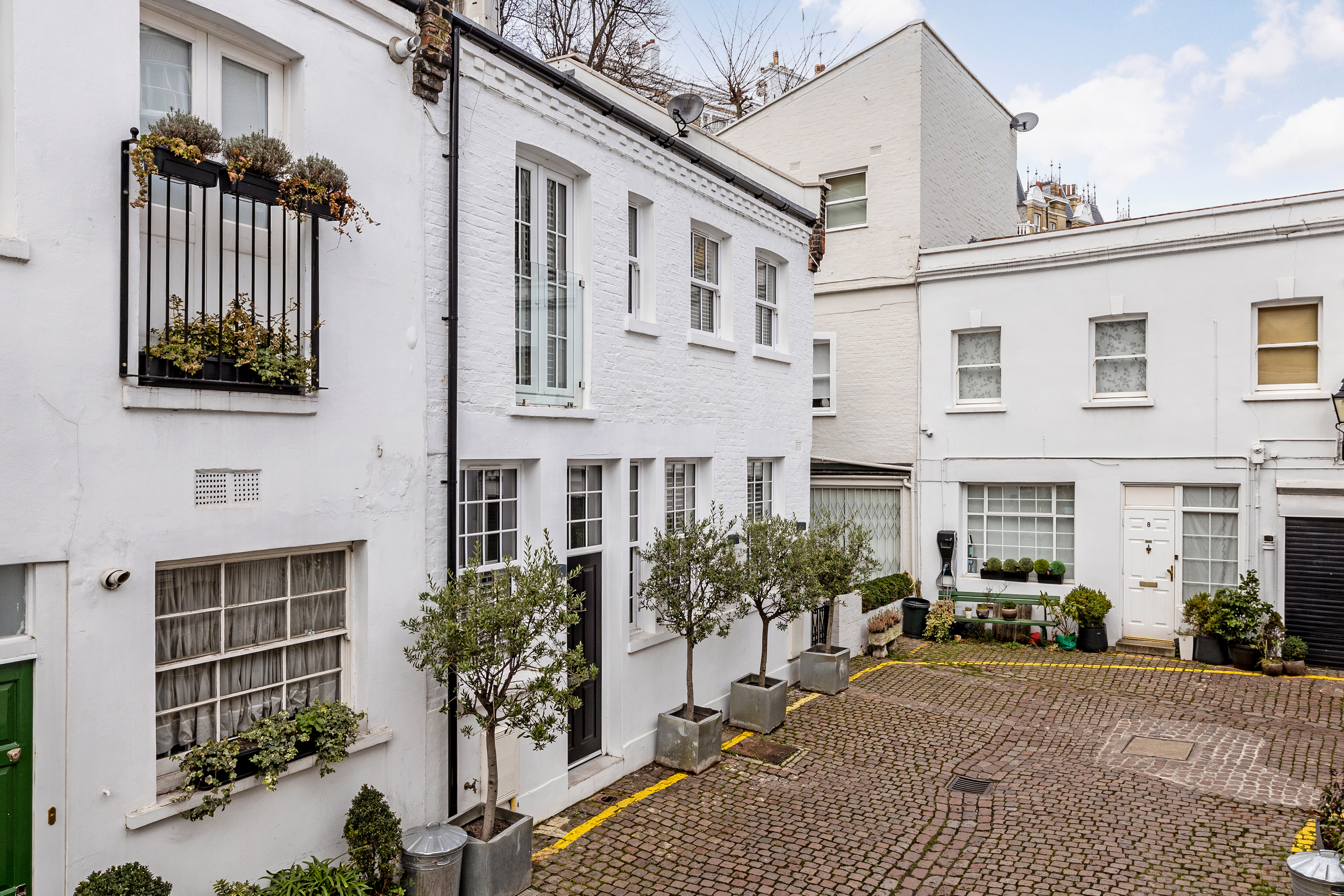 A white and black mews property in SW7