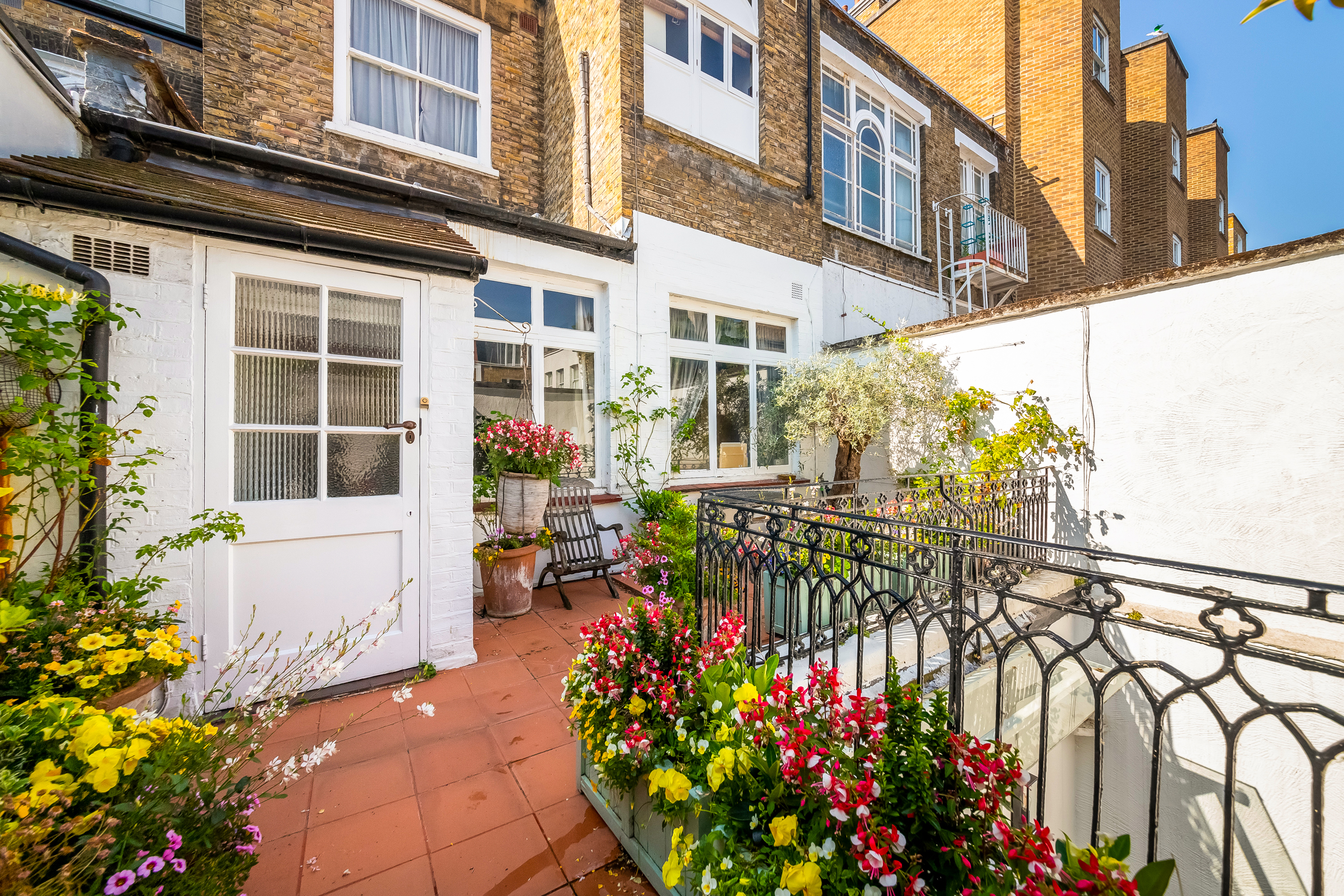Mews property with balcony with flowers and plants