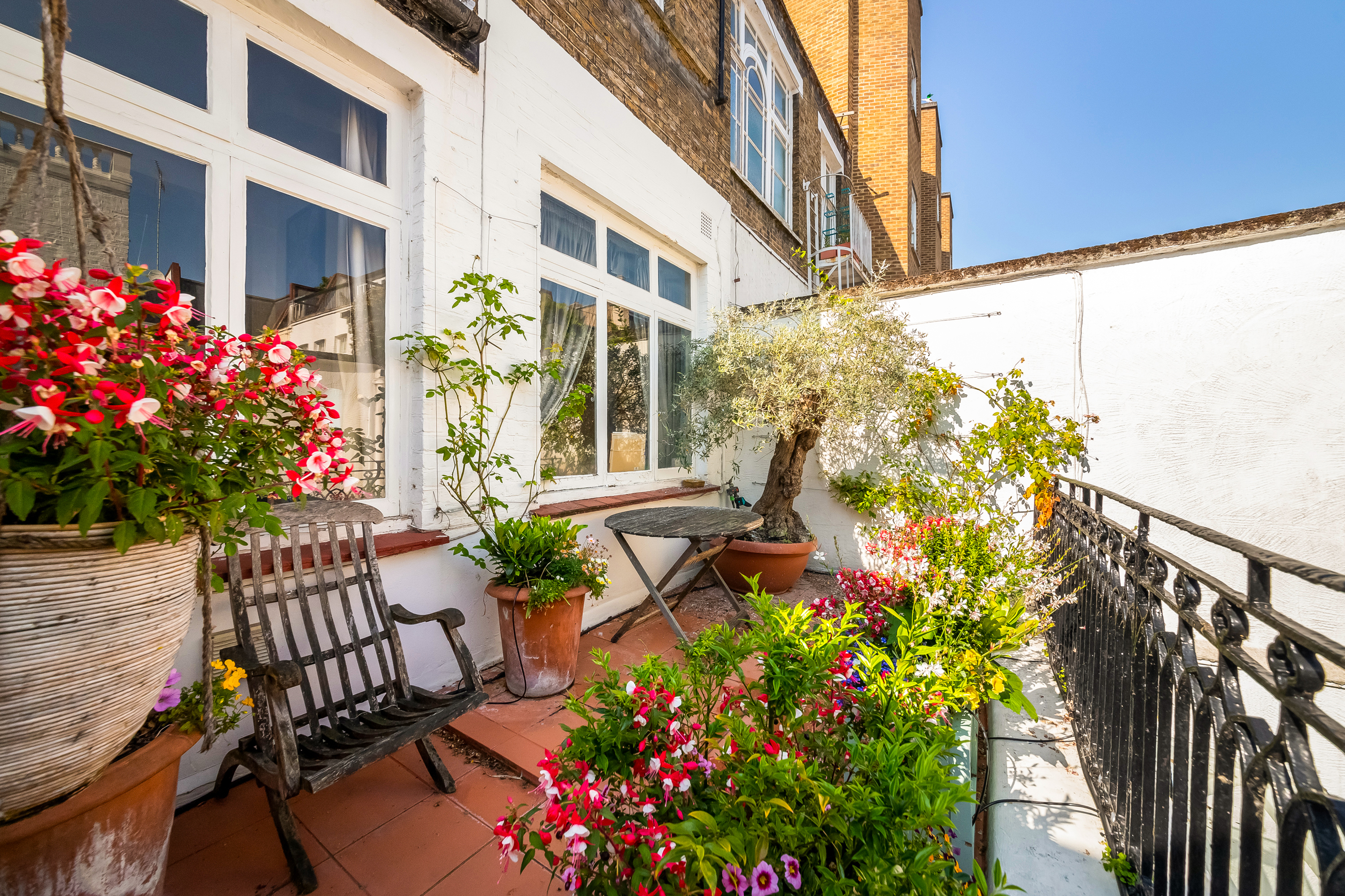 Mews property with a courtyard, a table and chair and plants