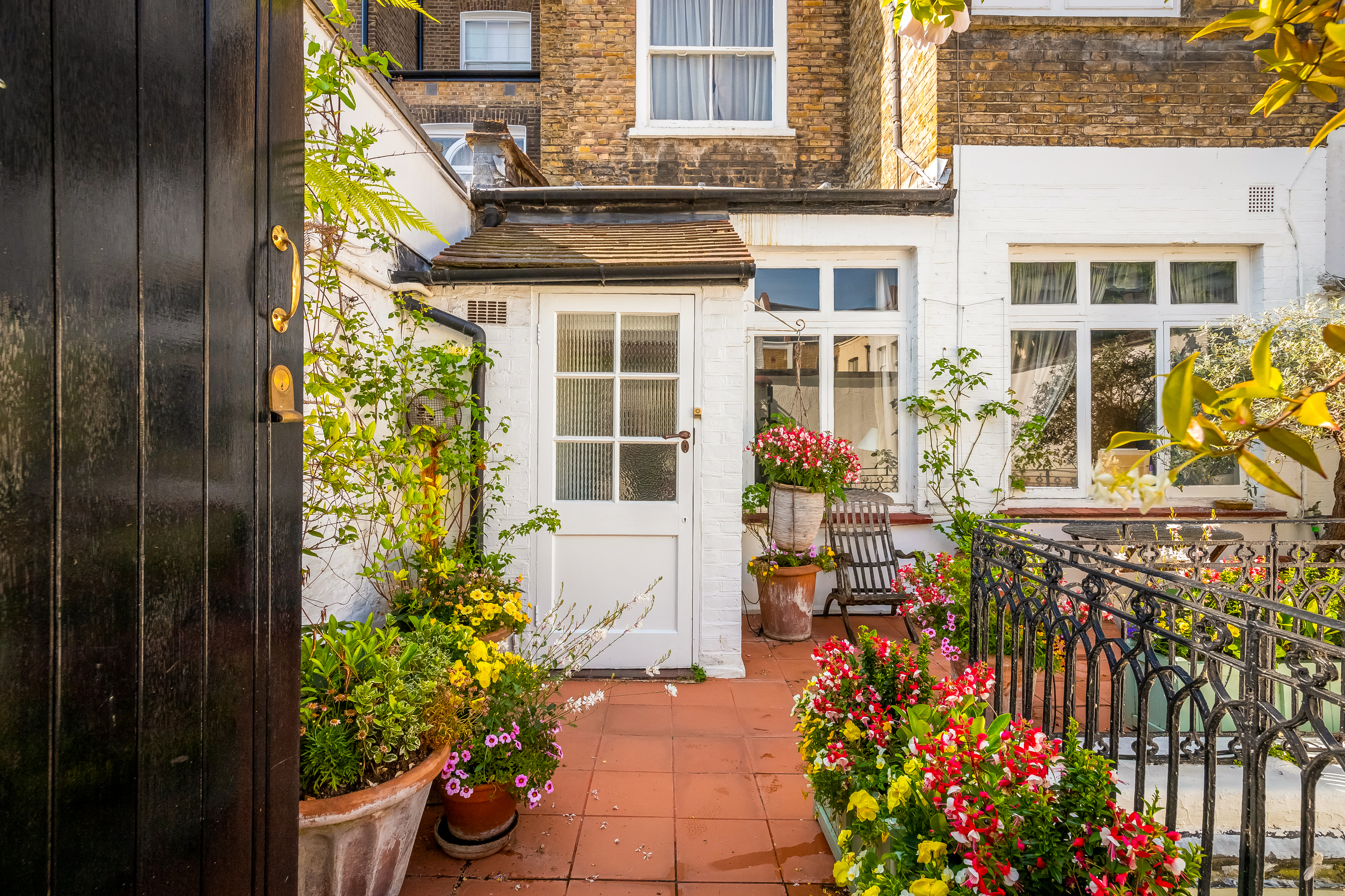 A mews property with a balcony and flowers