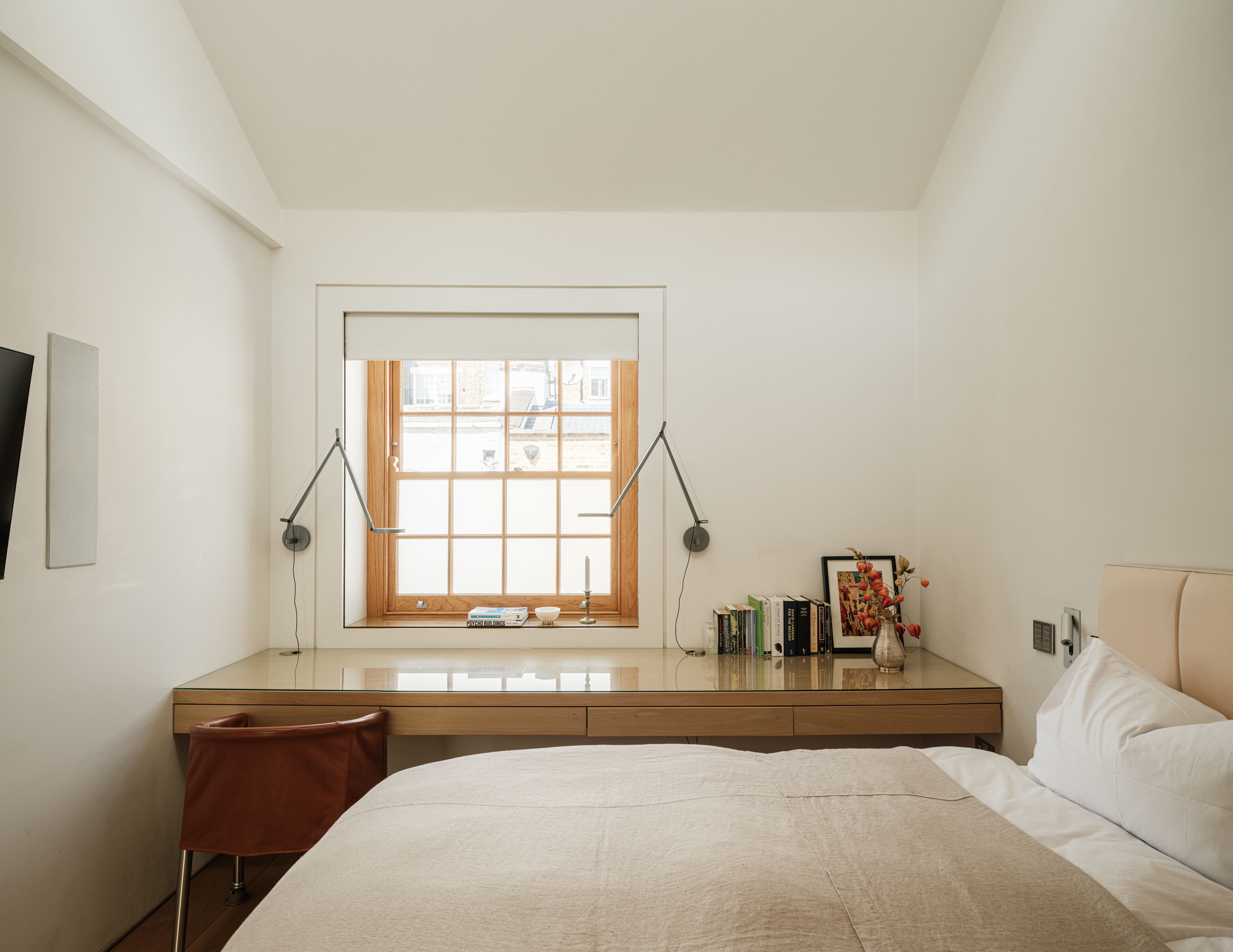 A bedroom in a mews property flooded with light