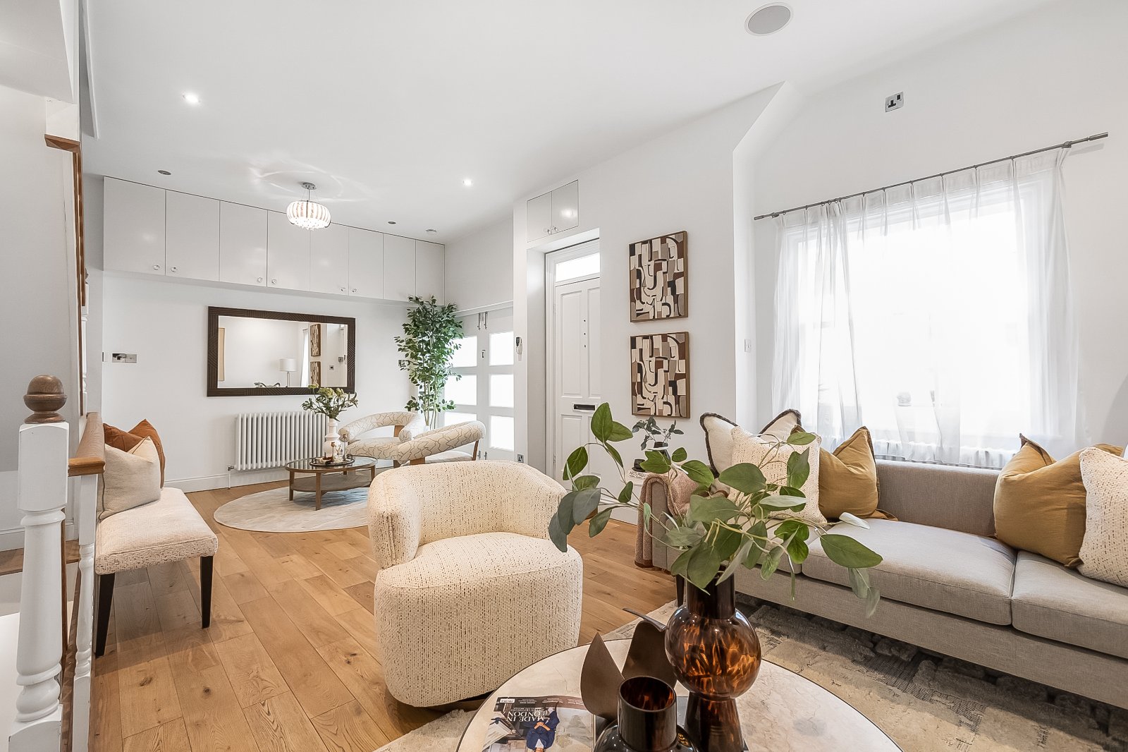 a living room with an armchair in a mews house for sale