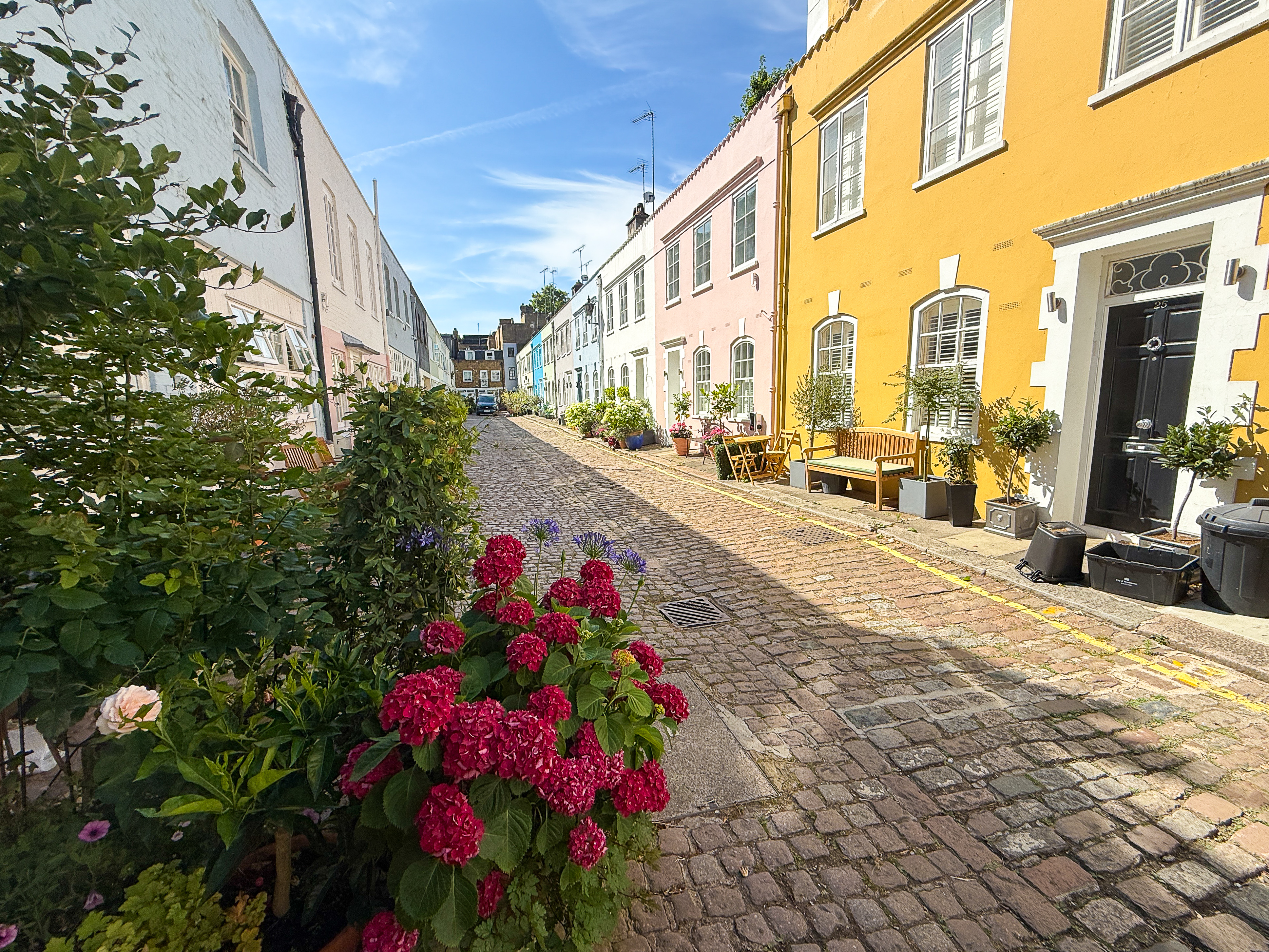 A Mews Street In London With A Yellow House