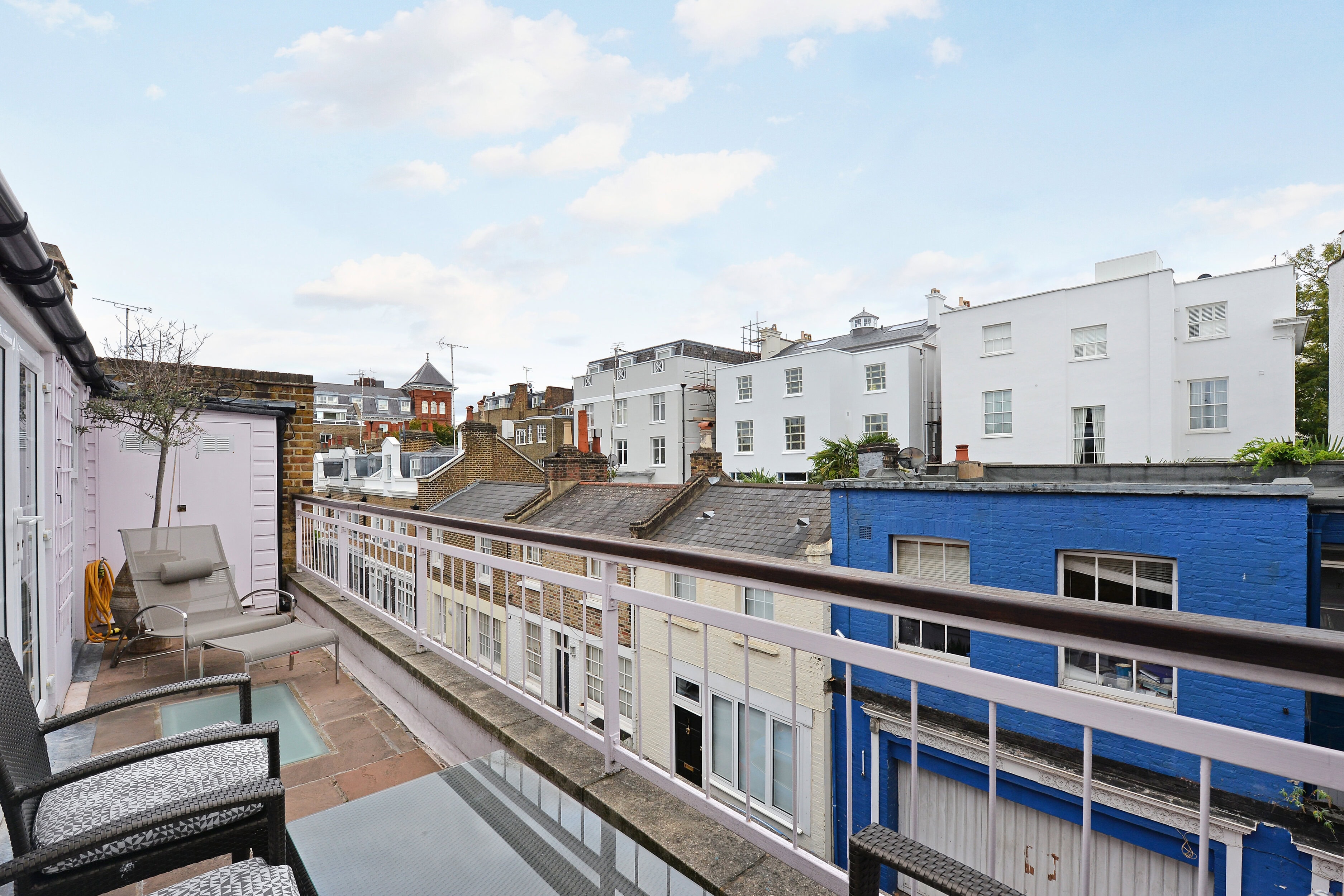 A rooftop from a house overlooking a mews street