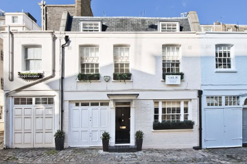 A pink mews house in a mews street