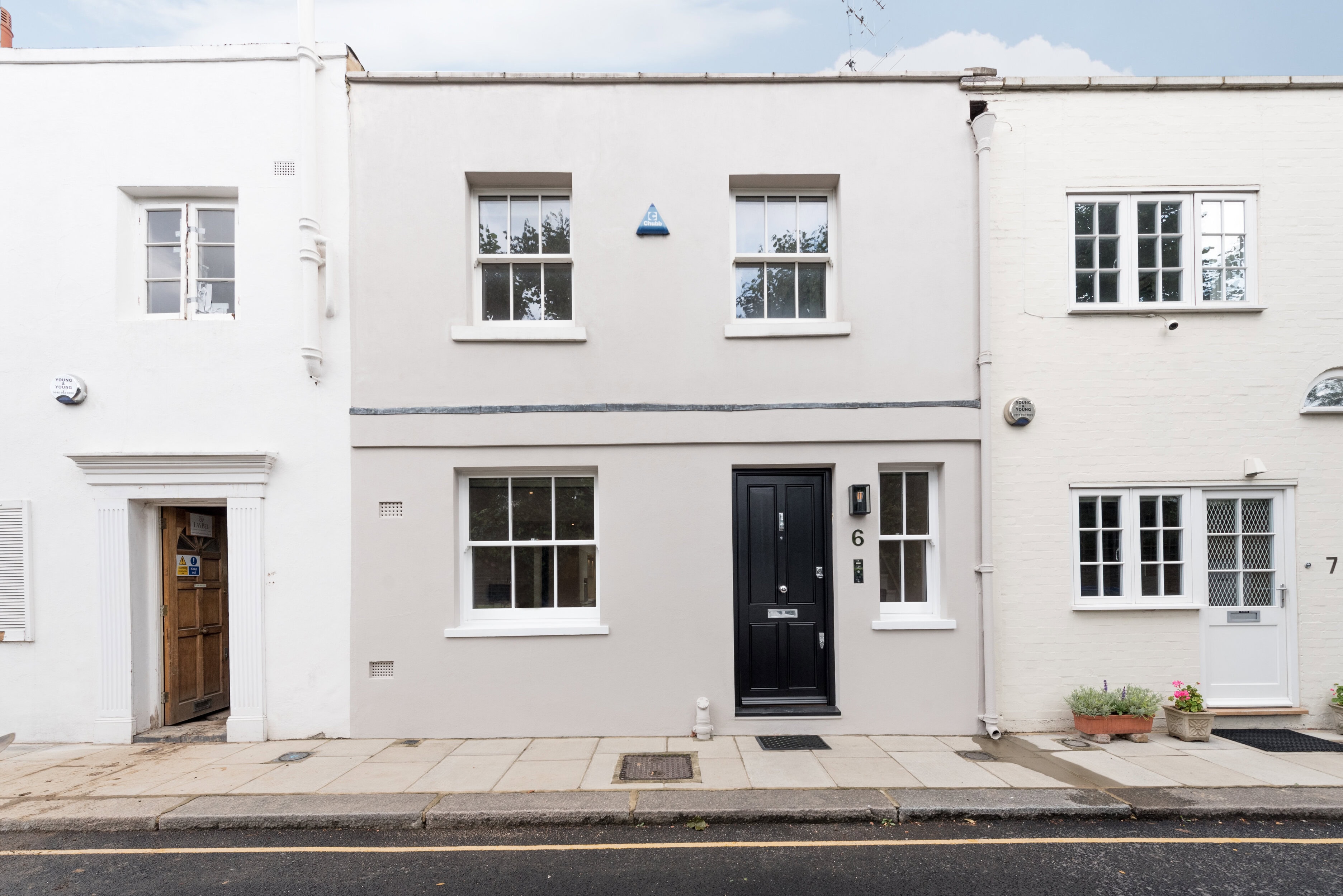 Grey house with a black door, similar to a mews property