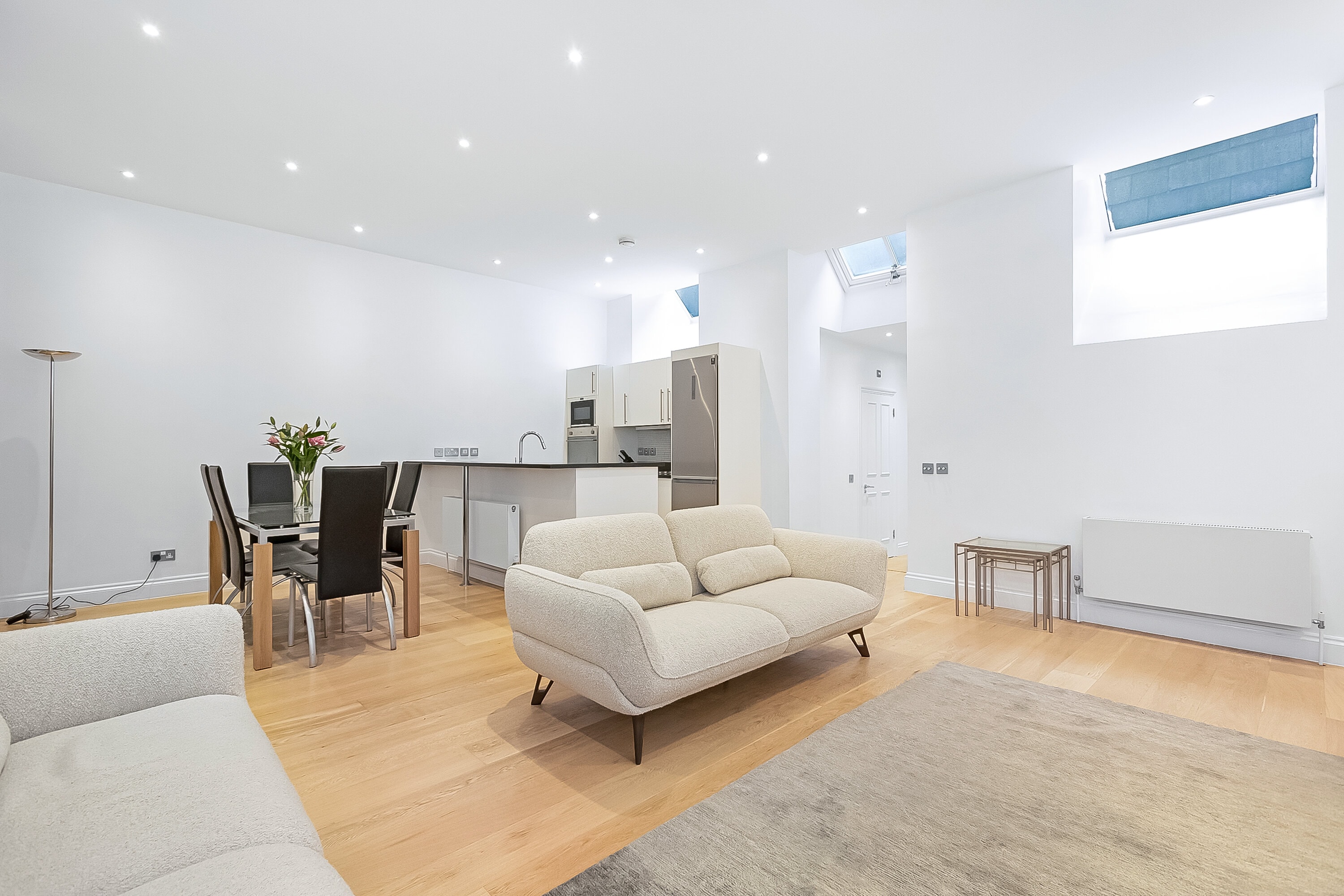 An open-plan living room, kitchen and dining room in a mews property