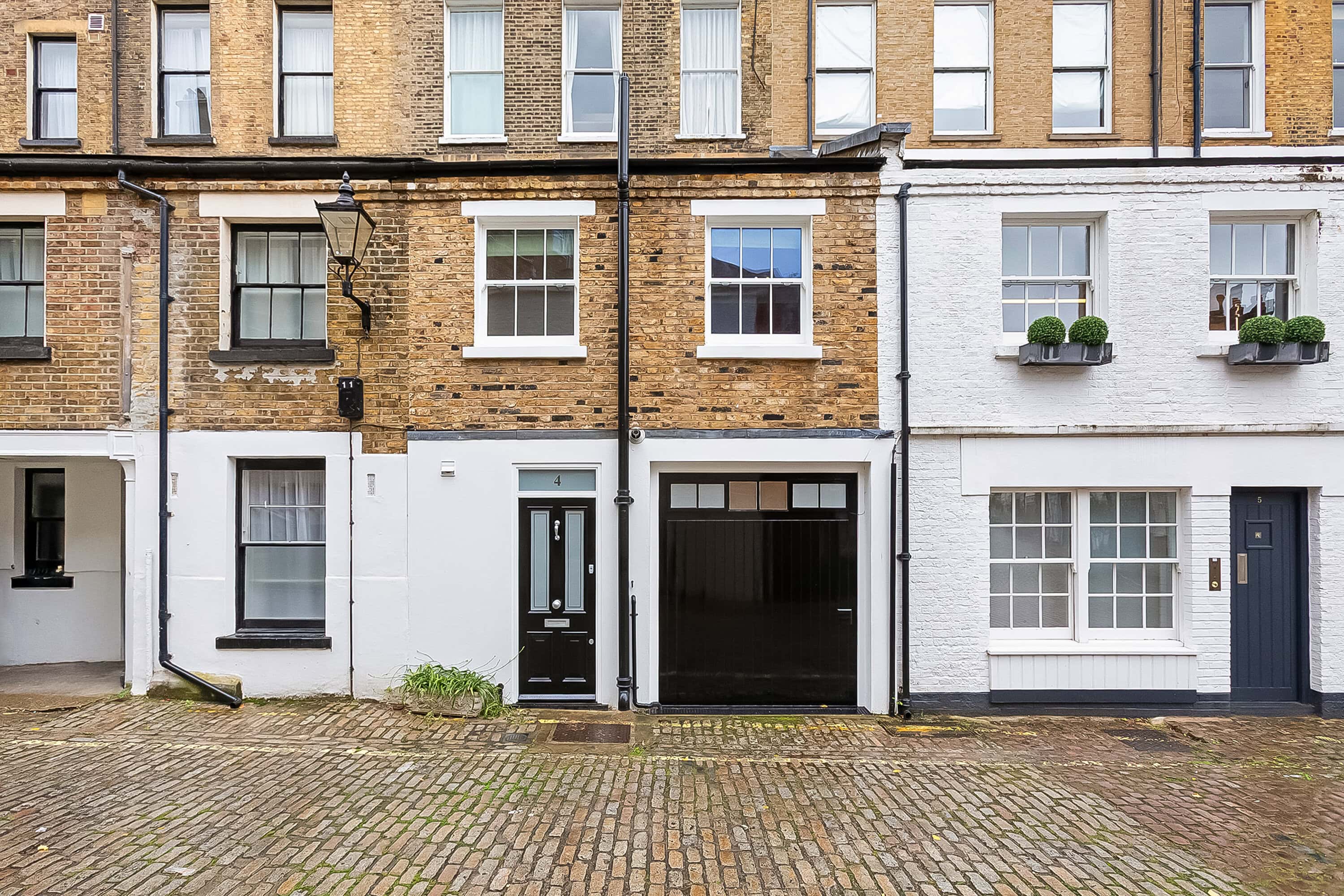 A mews house in London with a black door
