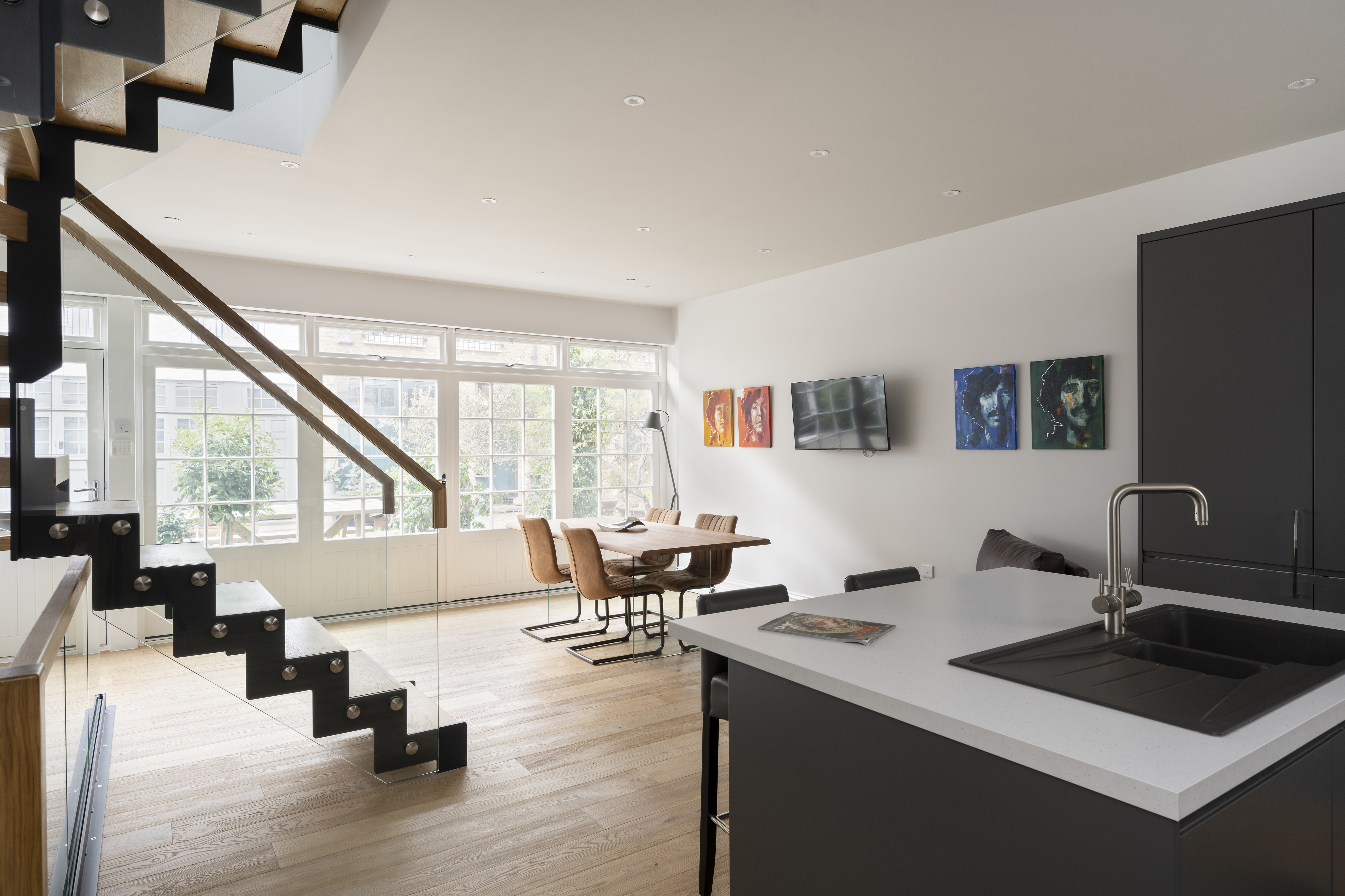 An open-plan kitchen in a mews house with a lot of light