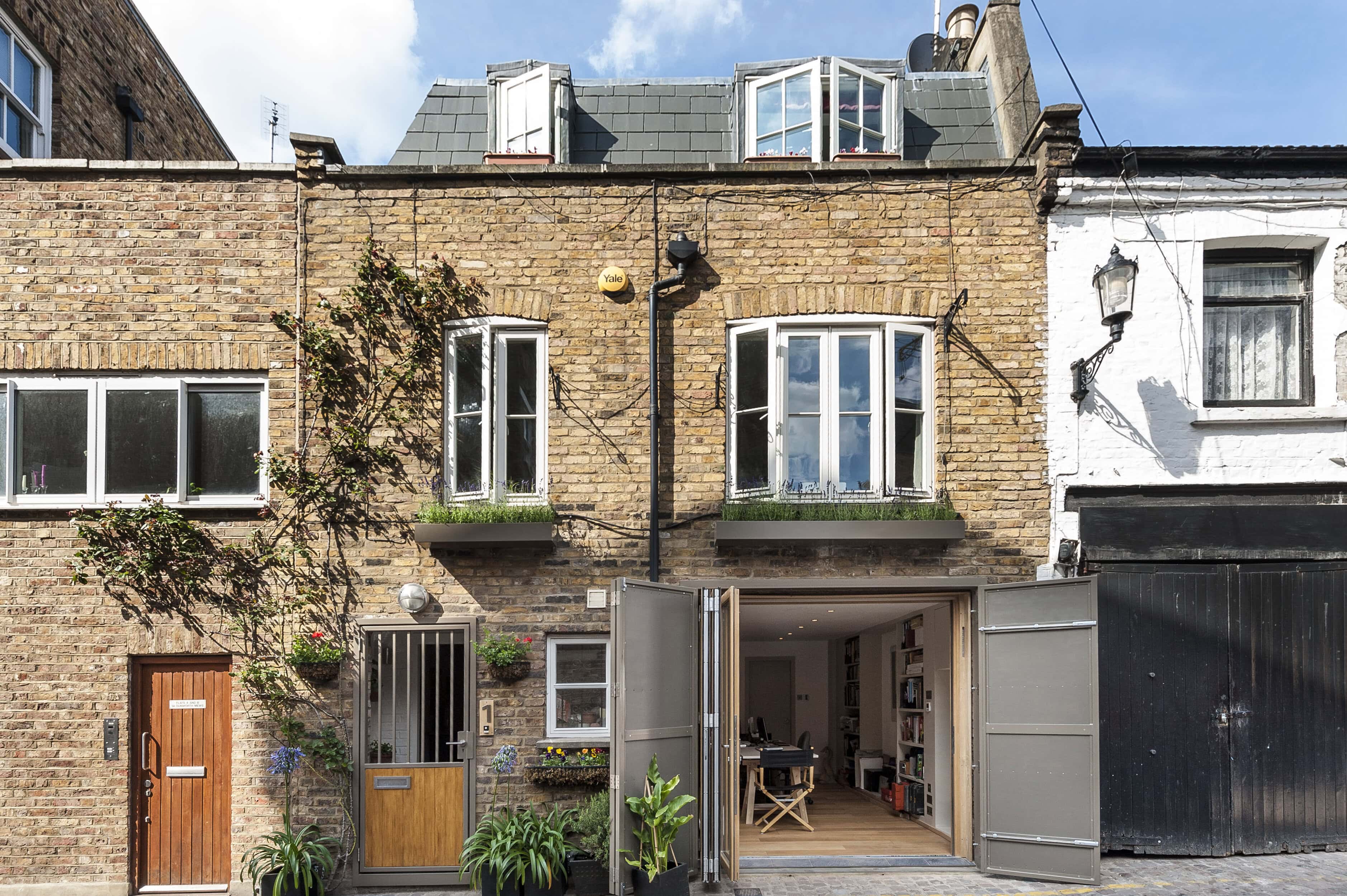 A mews house with open garage doors