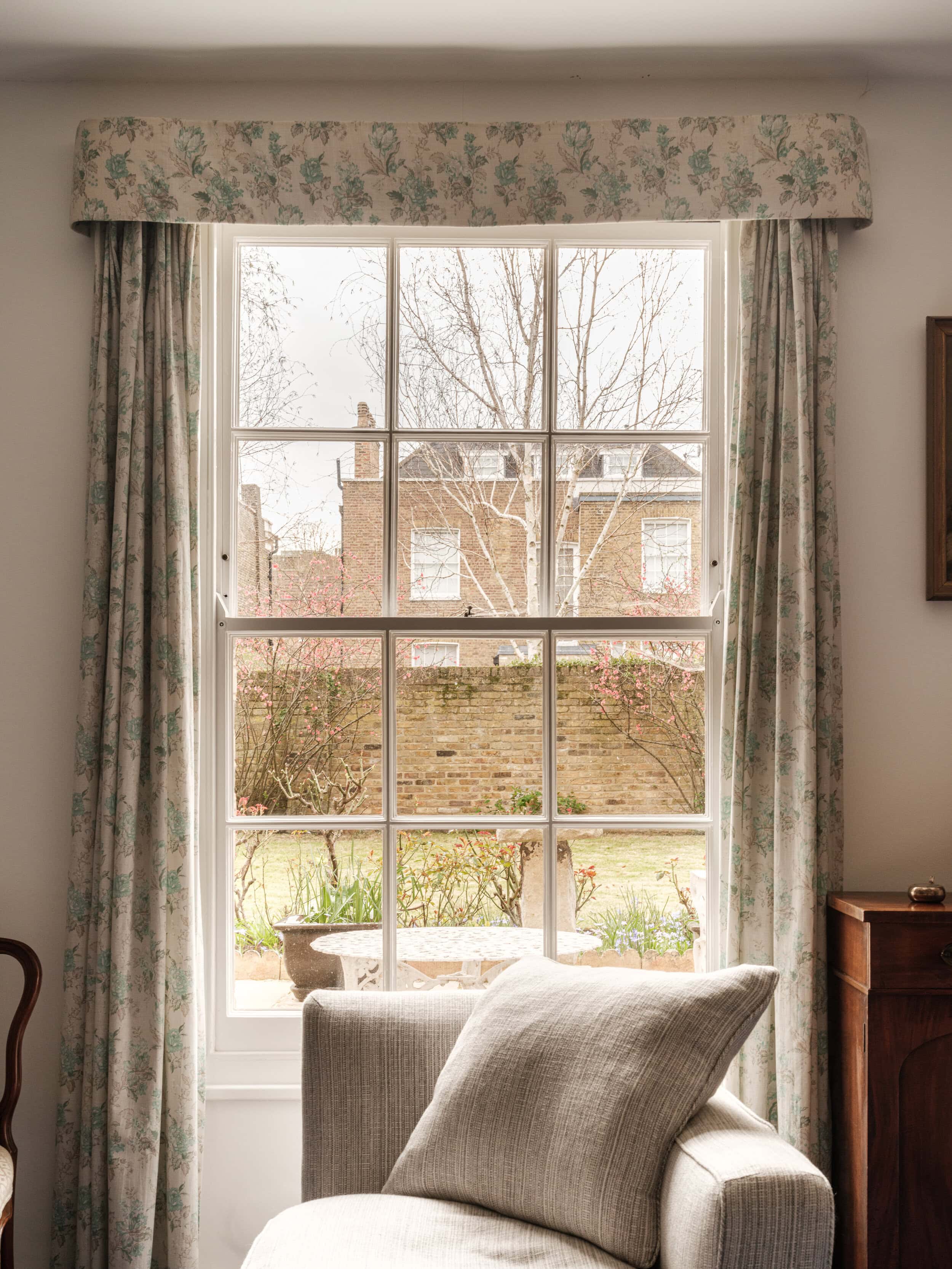 Country home décor ideas for your mews house with a grey sofa and window looking over the garden