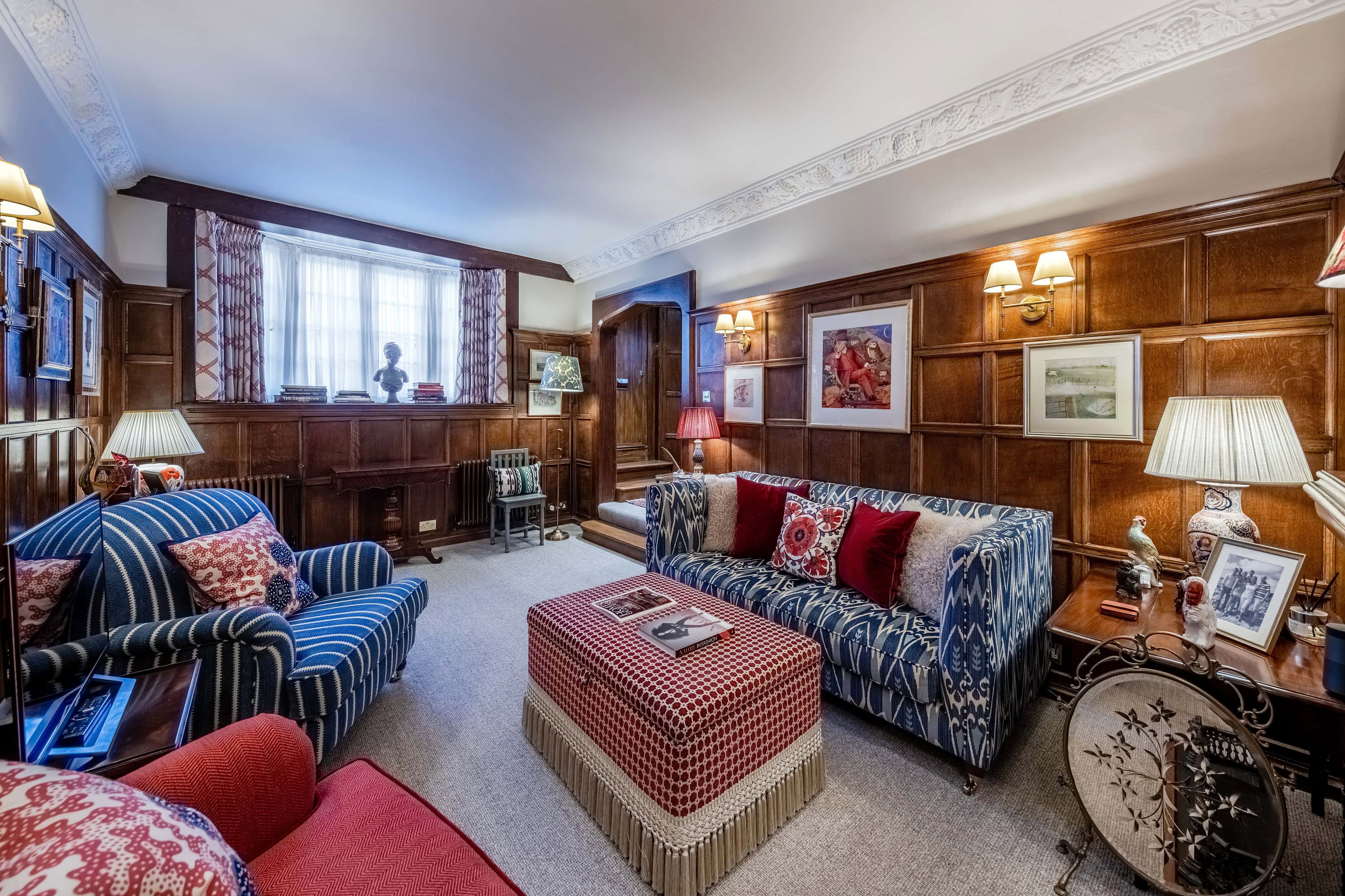 the wood-panelled living room of the charming mews home for rent on Cornwall Mews South.
