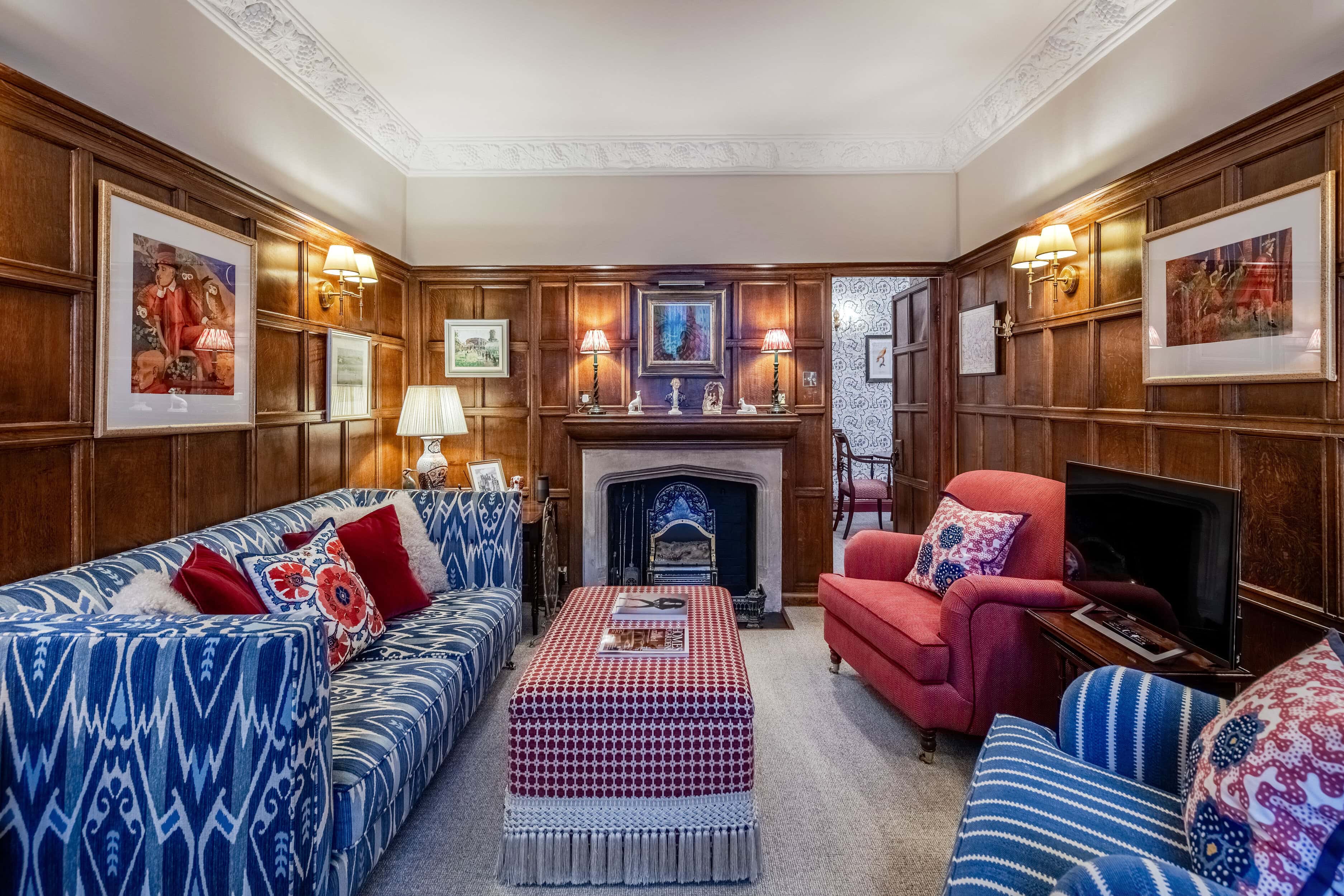 The wood-panelled living room inside the charming mews home for rent on Cornwall Mews South.