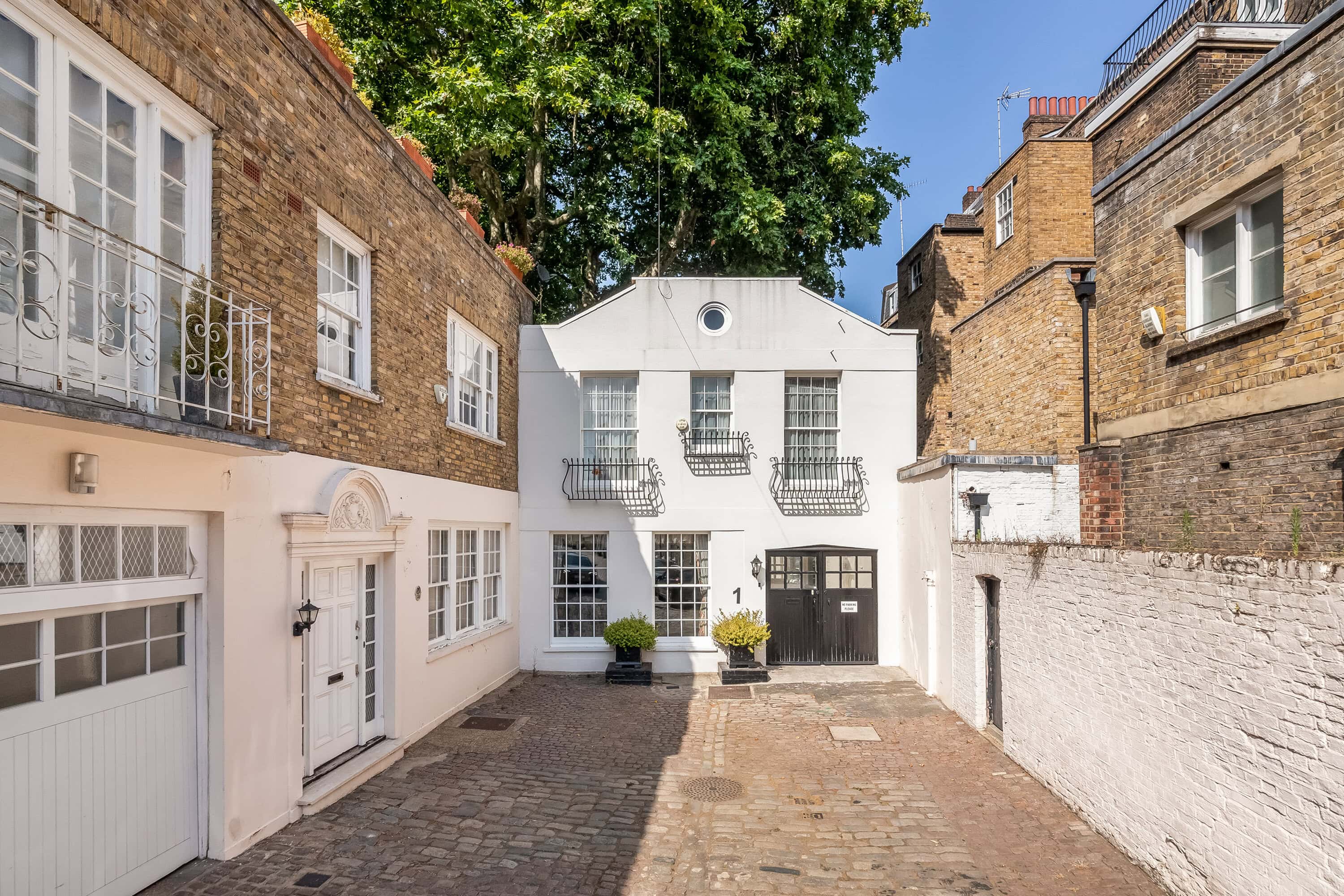 White mews house at the end of Ebury Mews East, a charming prime London mews street.