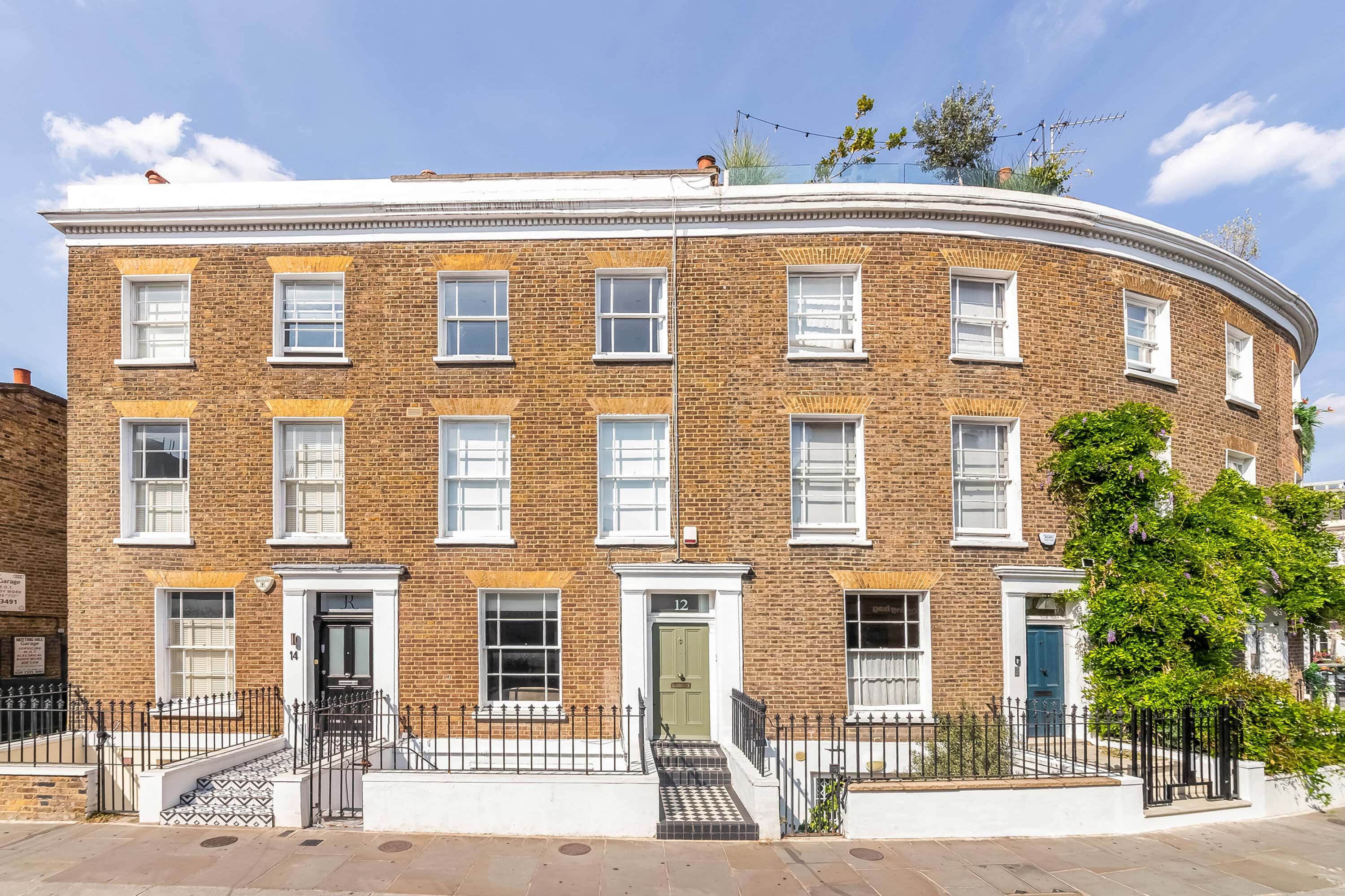 Elegant terraced house in Notting Hill with classic architecture and greenery.