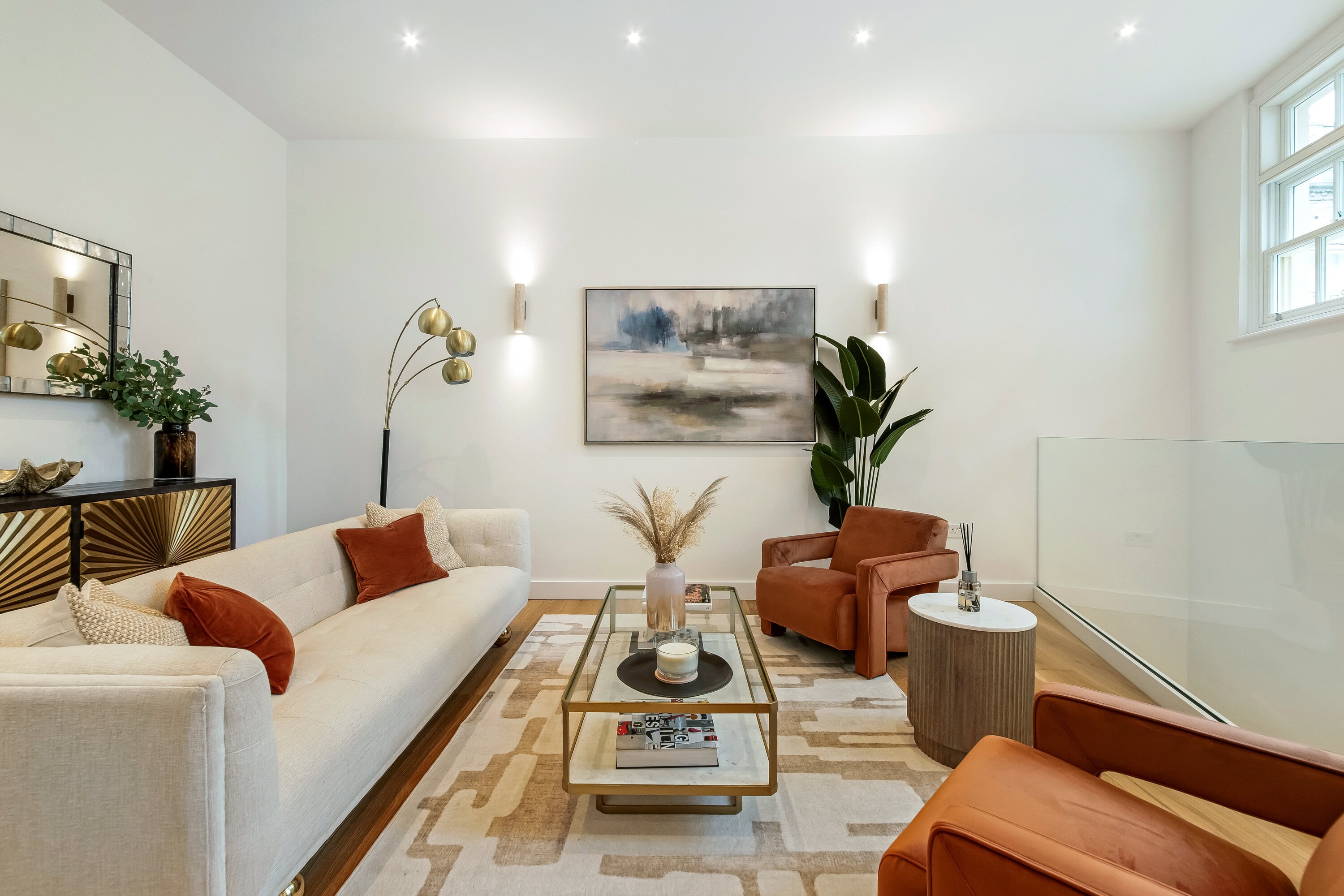 The bright, stylish living room with contemporary furniture and decor in a home for rent in Lexham Mews, W8.