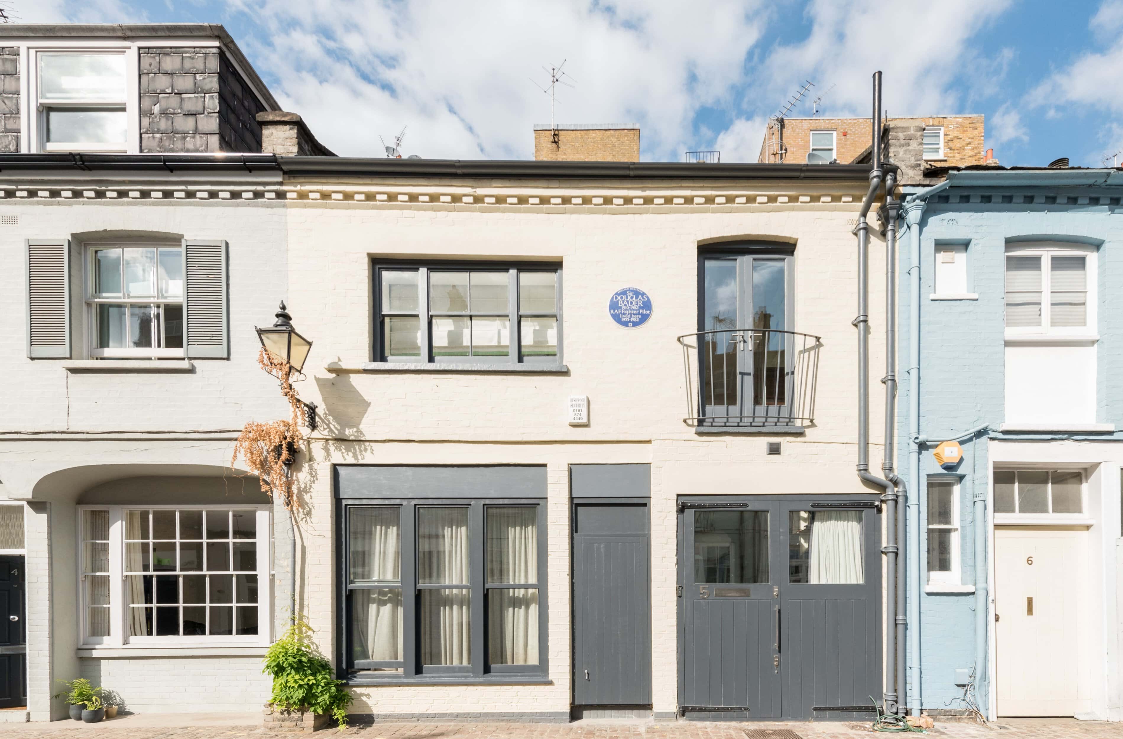 Historic London mews house with blue plaques and traditional architecture.